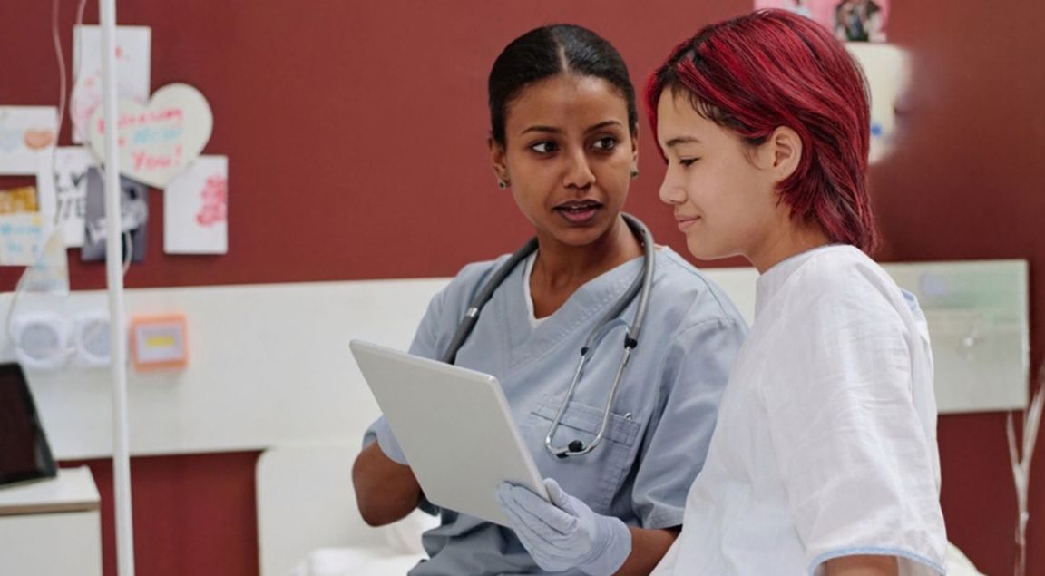 Teen in hospital talking to nurse about discharge