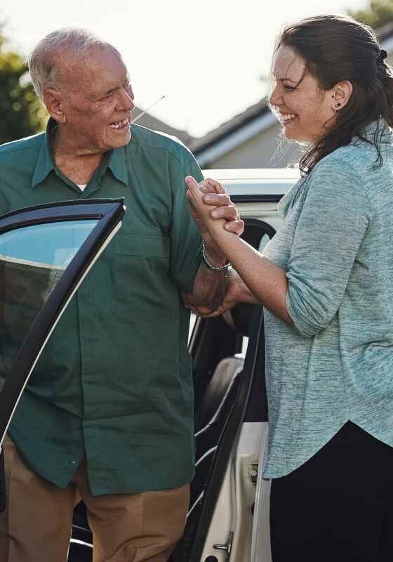 Older adult arriving at home in car