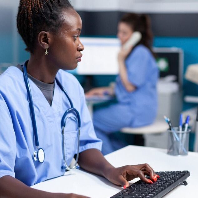 hospital worker making a care coordination referral on computer