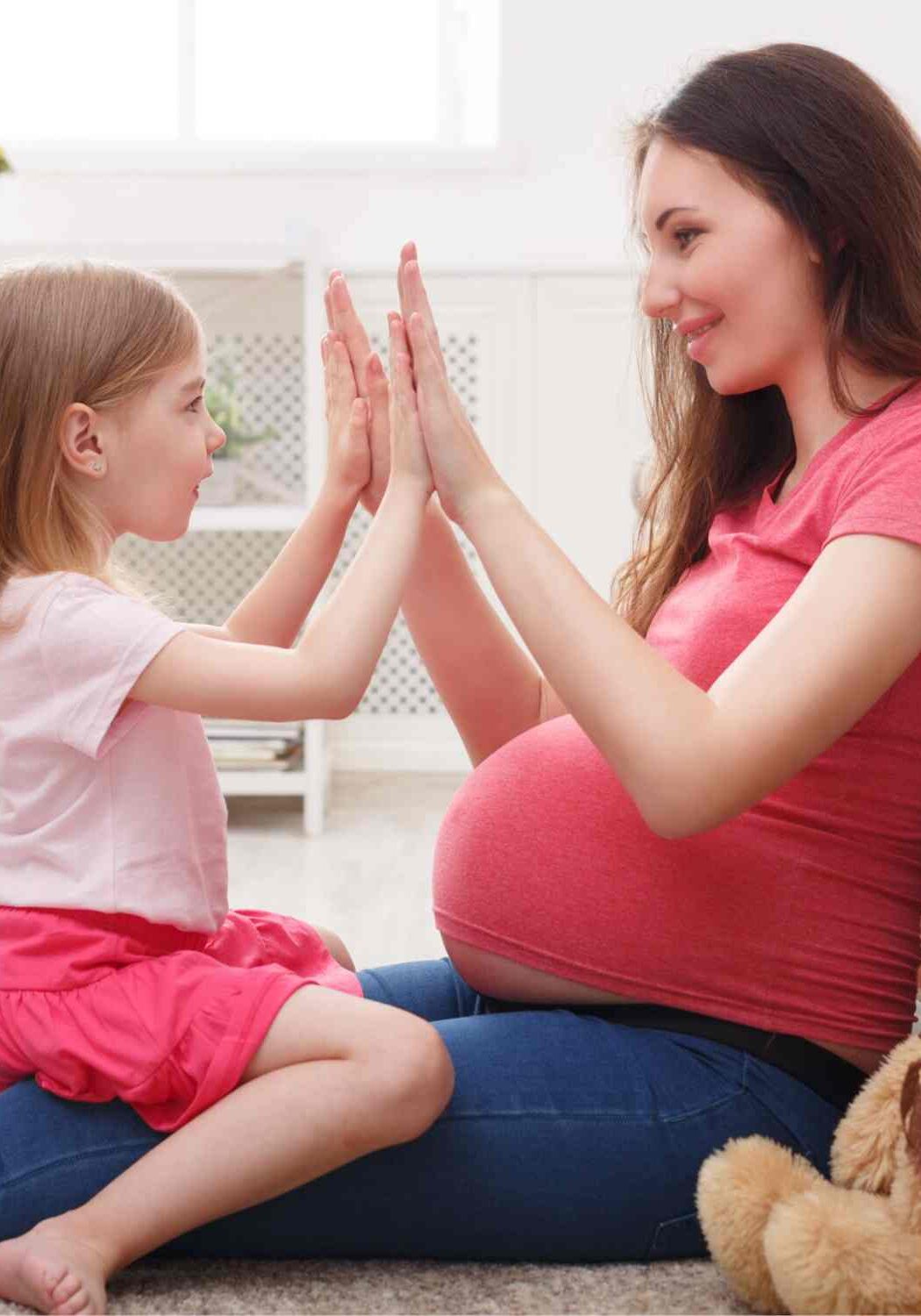pregnant mom and daughter playing